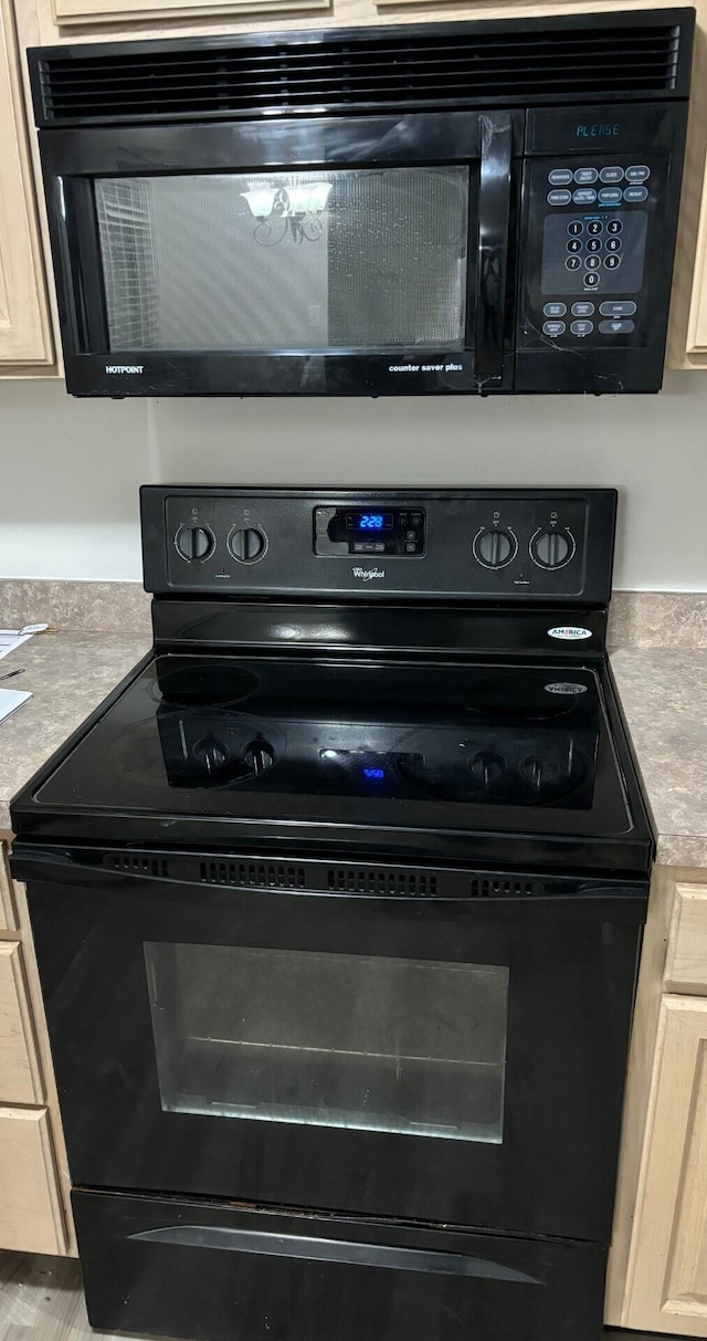 interior details featuring black appliances and light countertops