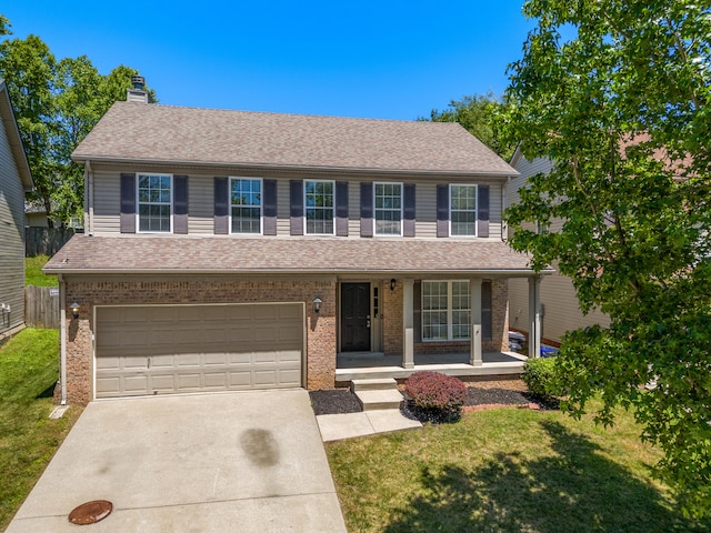 view of front of property featuring covered porch, brick siding, driveway, and a front lawn