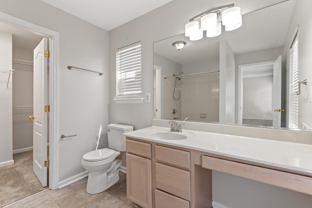 bathroom with baseboards, a shower, toilet, a spacious closet, and vanity