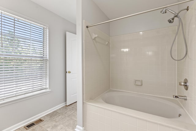 bathroom featuring shower / tub combination, visible vents, and baseboards