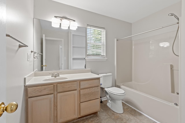 bathroom with tub / shower combination, vanity, and toilet