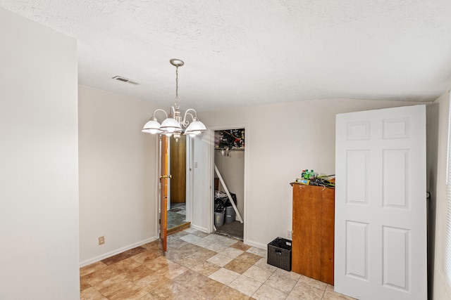 858 Lylesville St, Paris, KY 40361 - unfurnished dining area featuring a chandelier, baseboards, a textured ceiling, and vaulted ceiling