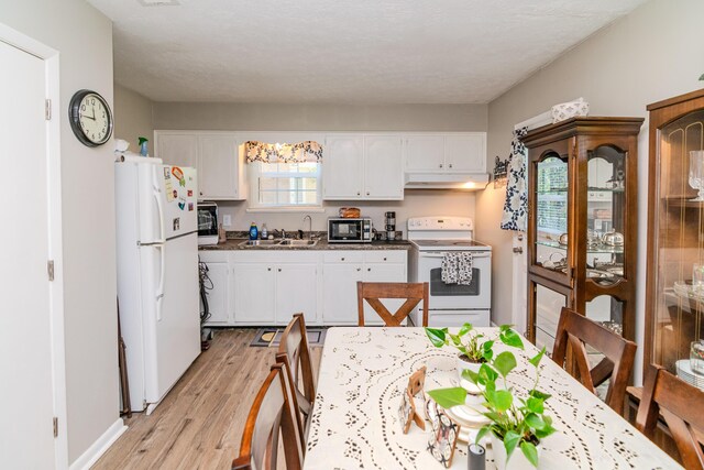 kitchen with sink, light hardwood / wood-style floors, a textured ceiling, white appliances, and white cabinets