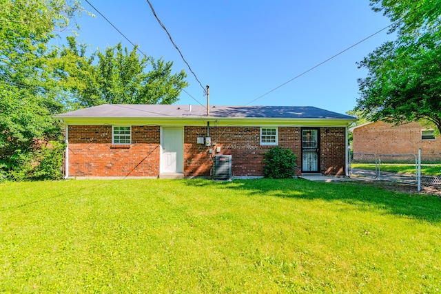 rear view of house featuring a yard