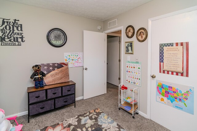 game room with carpet floors and a textured ceiling