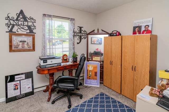 office area featuring a textured ceiling, light carpet, and a baseboard heating unit