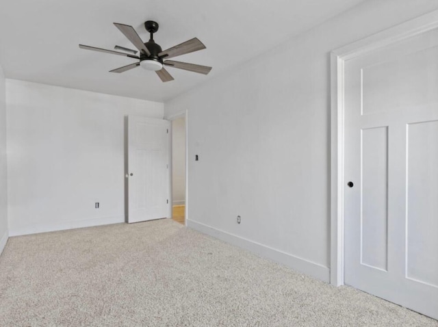 unfurnished room with ceiling fan and carpet floors