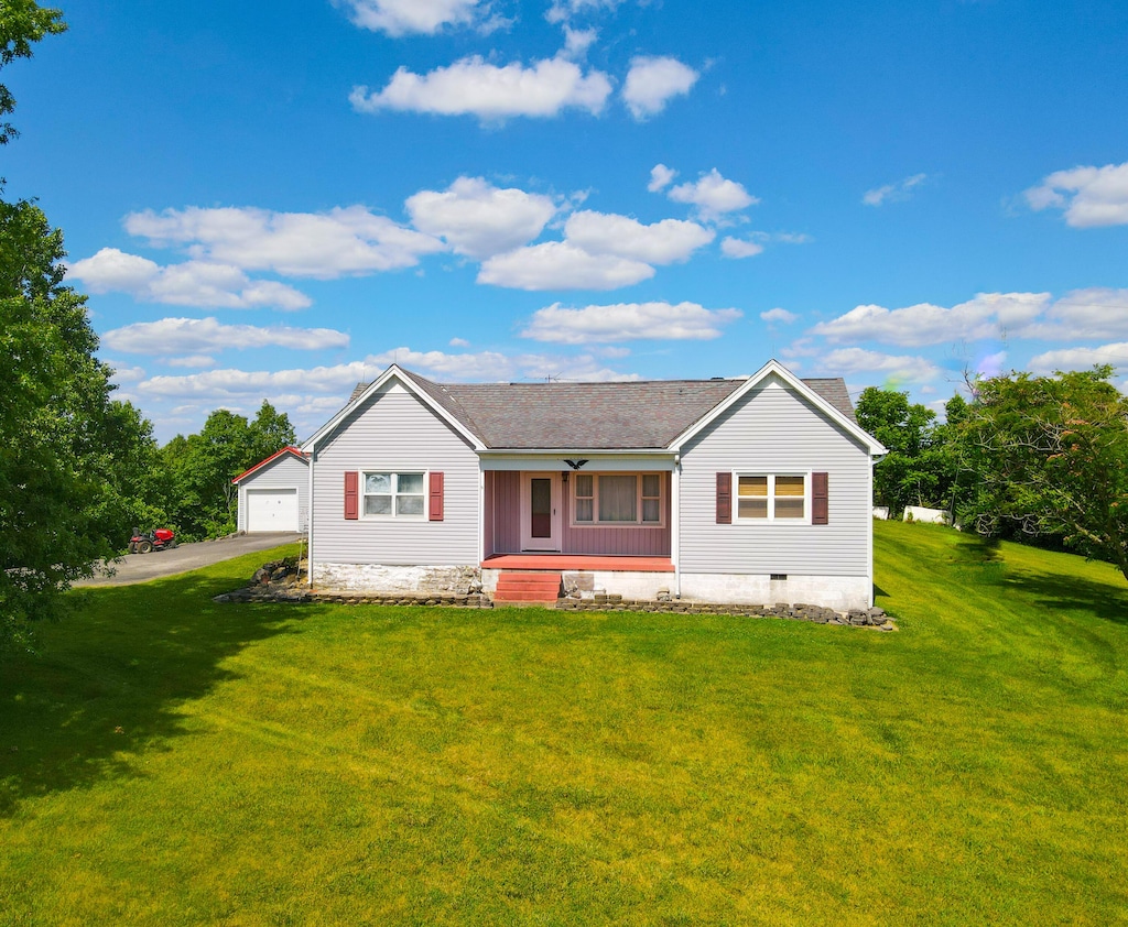 rear view of house featuring a lawn