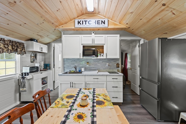 kitchen with stainless steel refrigerator, white cabinets, and dark wood-type flooring