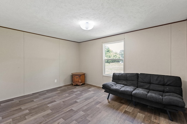 sitting room featuring hardwood / wood-style floors and a textured ceiling