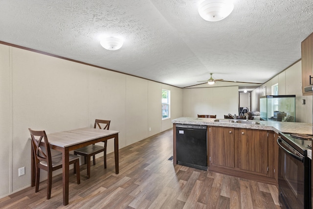 kitchen with a textured ceiling, ceiling fan, sink, black appliances, and dark hardwood / wood-style floors