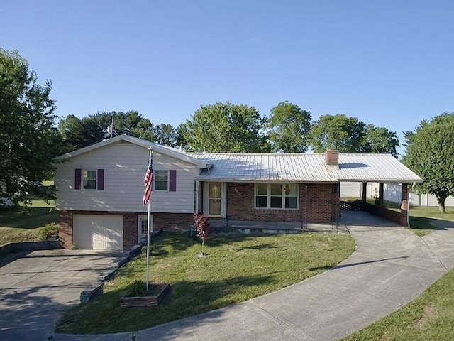 split level home featuring driveway, brick siding, metal roof, an attached carport, and a front yard