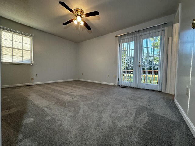 empty room with ceiling fan and carpet flooring