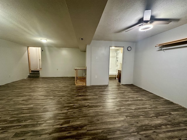 interior space featuring dark wood-style floors, visible vents, stairway, a ceiling fan, and a textured ceiling