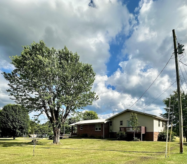 view of property exterior with a wooden deck and a lawn