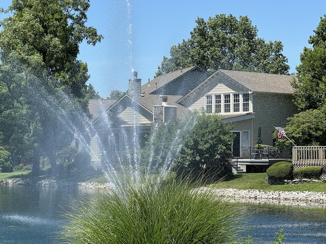 exterior space featuring a deck with water view