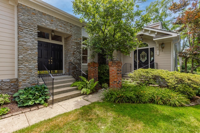 view of exterior entry featuring a yard