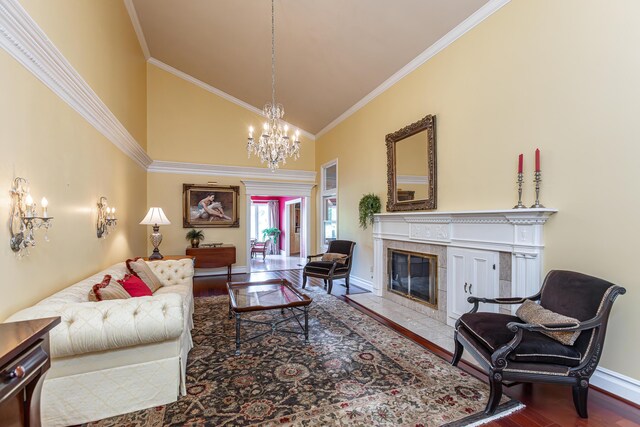 entrance foyer with a towering ceiling, light wood-type flooring, ornate columns, and ornamental molding