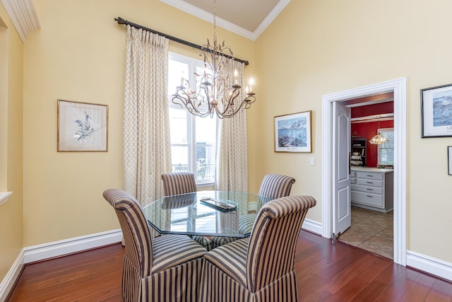 dining room with an inviting chandelier, crown molding, dark wood-type flooring, and a baseboard radiator