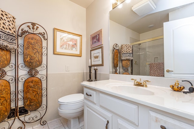 bathroom with tile patterned flooring, vanity, toilet, and a shower with shower door