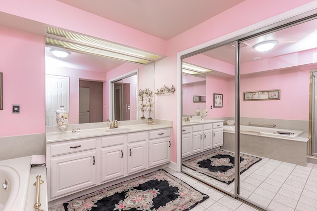 bathroom featuring tile patterned floors, vanity, and a bathing tub