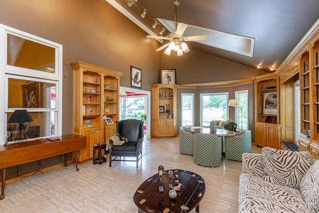 living room with ceiling fan, track lighting, and high vaulted ceiling