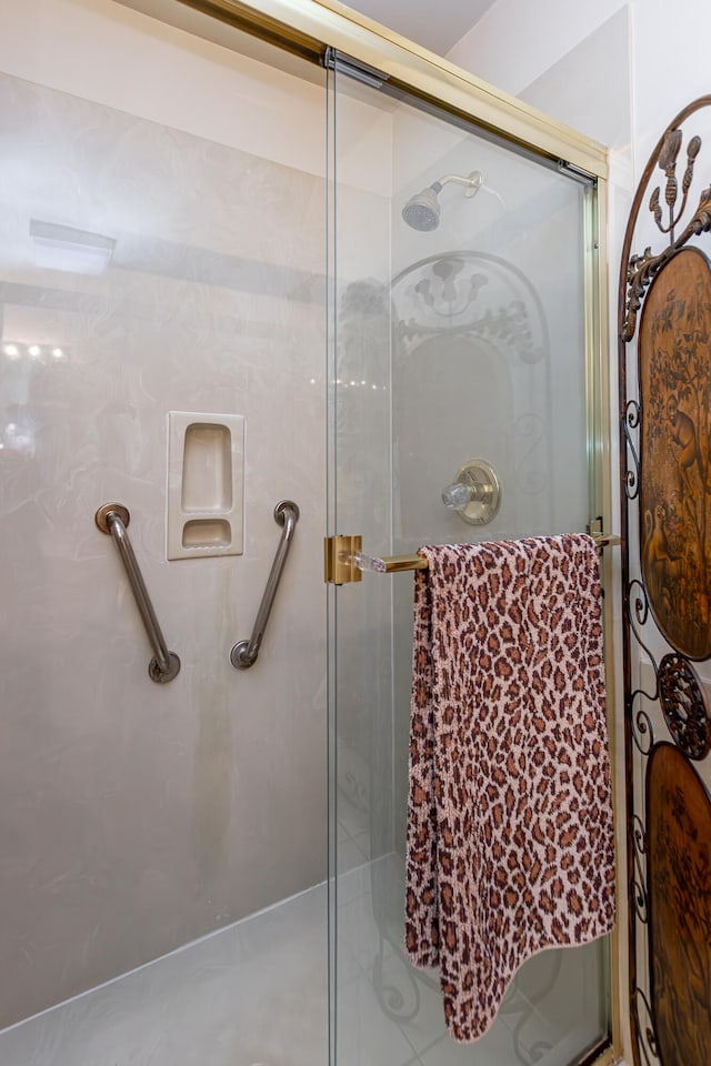 bathroom with a shower with shower door