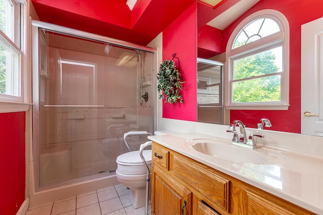 bathroom featuring walk in shower, vanity, toilet, and tile patterned flooring