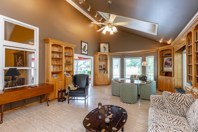 living room featuring ceiling fan and high vaulted ceiling