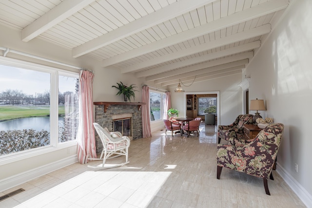 sunroom / solarium with a chandelier, beamed ceiling, and a water view