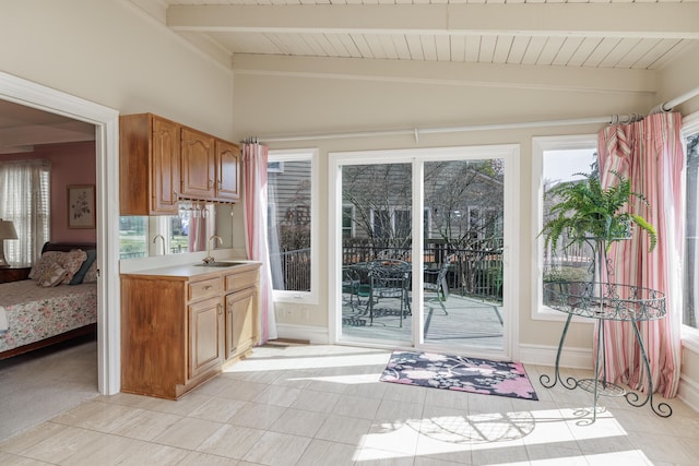 kitchen featuring vaulted ceiling with beams, sink, wood ceiling, and light tile patterned floors