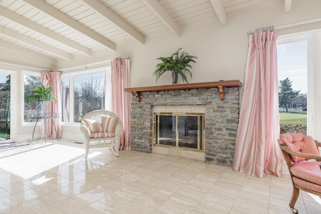 sitting room with a brick fireplace, vaulted ceiling with beams, and wooden ceiling