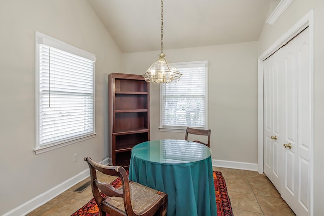 tiled dining area with vaulted ceiling