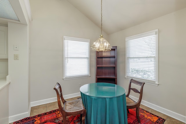 tiled dining space featuring lofted ceiling and a chandelier