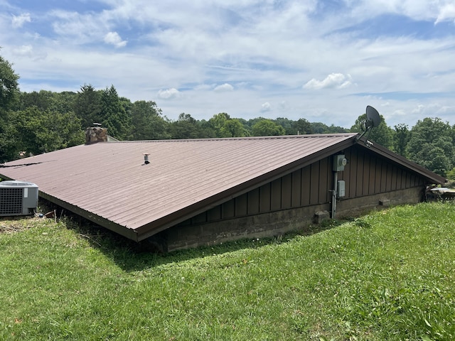 exterior space with a yard and central air condition unit