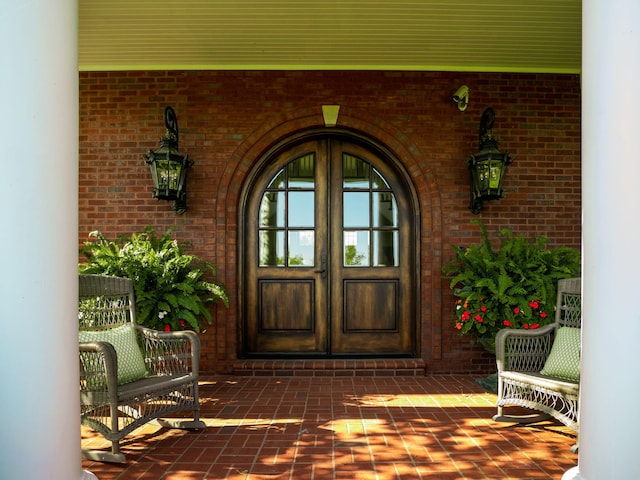 entrance to property featuring brick siding