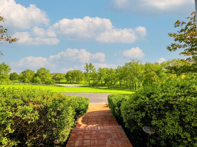 surrounding community with a yard and fence