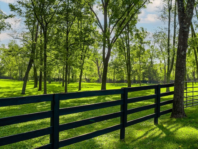 view of gate featuring a lawn and fence