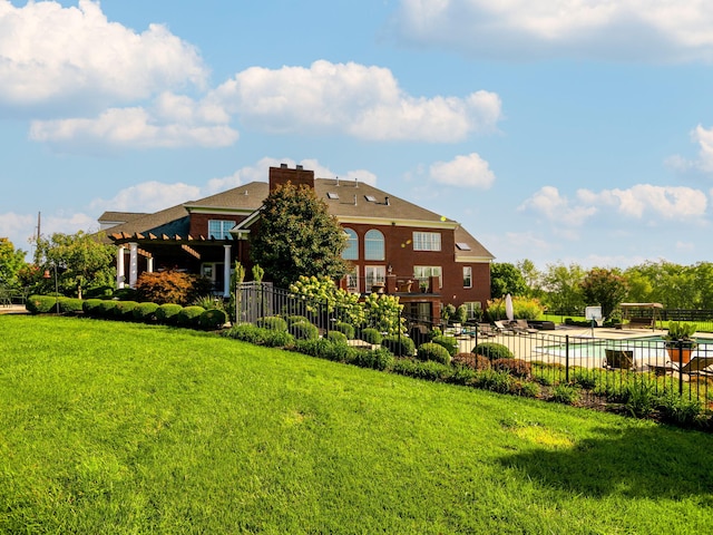 exterior space featuring a lawn, a chimney, a patio, and fence