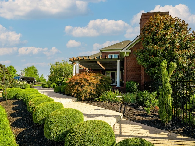 view of yard featuring a pergola and fence