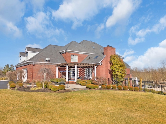 back of house with a lawn, a pergola, a patio, fence, and a chimney