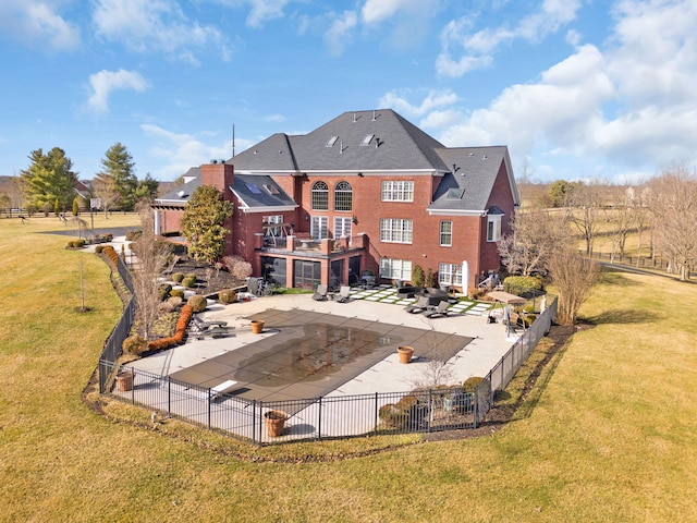 rear view of house featuring a patio area, a yard, and fence