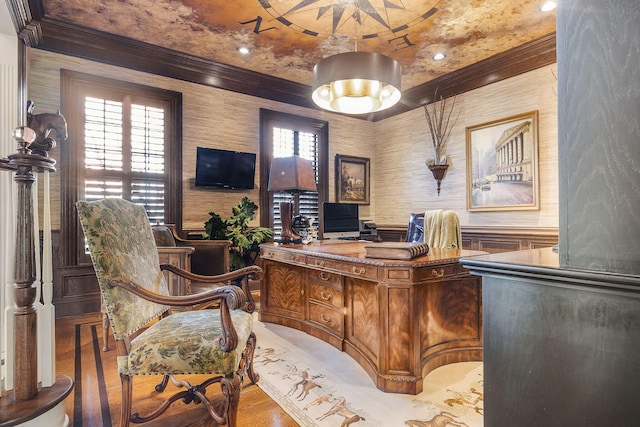 office area featuring a wainscoted wall, wallpapered walls, crown molding, and wood finished floors