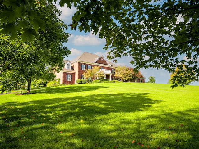 exterior space featuring a front lawn and brick siding