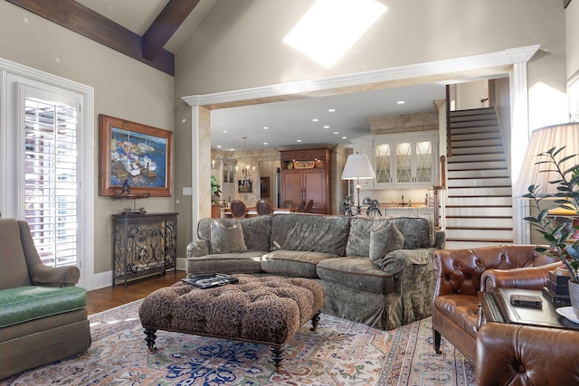 living room featuring baseboards, stairway, beam ceiling, recessed lighting, and wood finished floors