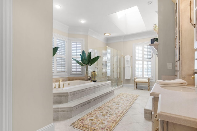 full bath featuring tile patterned floors, a garden tub, ornamental molding, a skylight, and a shower stall