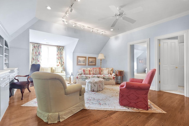 living area featuring a ceiling fan, crown molding, wood finished floors, and lofted ceiling