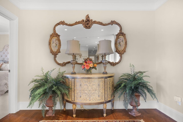 interior details featuring crown molding, wood finished floors, and baseboards