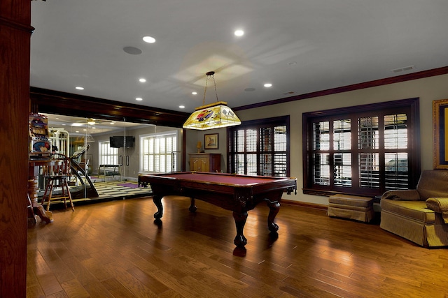 recreation room with recessed lighting, wood finished floors, visible vents, and ornamental molding