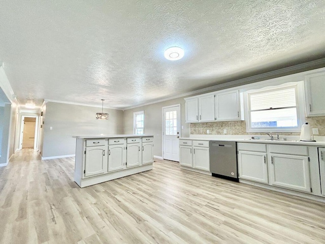 kitchen featuring pendant lighting, tasteful backsplash, white cabinetry, dishwasher, and ornamental molding